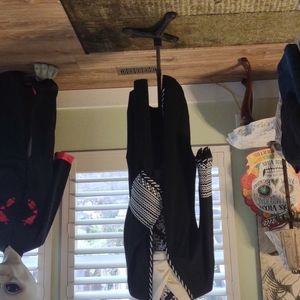 Full length sweater. Fringe on bottom of sleeves and a pattern in black & white.